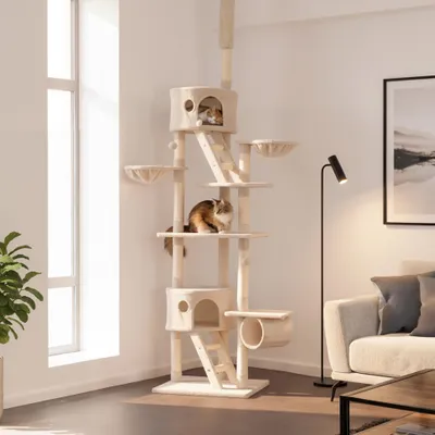 A cat tree is shown in a living room setting with two cats on it.