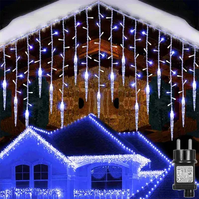 Icicle lights are decorating a house roof and eaves during winter.