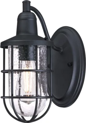 A black outdoor wall light with a clear glass shade and a metal cage.