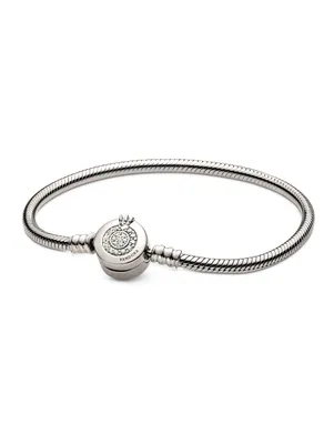 A silver Pandora bracelet with a clasp featuring a crown design and small stones.