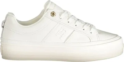 A white Tommy Hilfiger sneaker with a platform sole is shown against a white background.