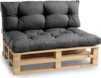 A dark gray sofa cushion set on a wooden pallet base, presented against a white background.