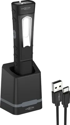 A black rechargeable inspection light with a charging station and USB-C cable on a white background.