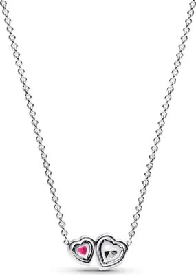 A close-up studio shot of a silver necklace with two heart-shaped pendants.