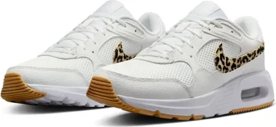 A pair of white Nike sneakers with leopard print accents on the swoosh.