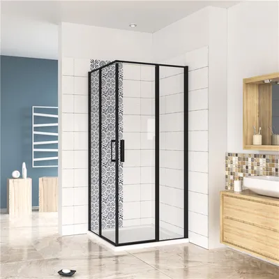 A modern bathroom with a black framed glass shower enclosure, white tiled walls, and wooden vanity.