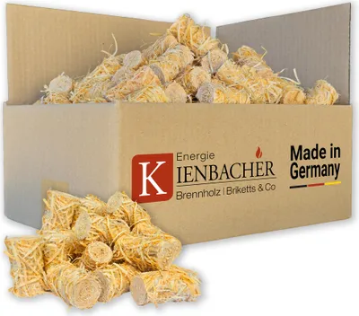 A cardboard box filled with wood wool fire starters, with some spilled in front.