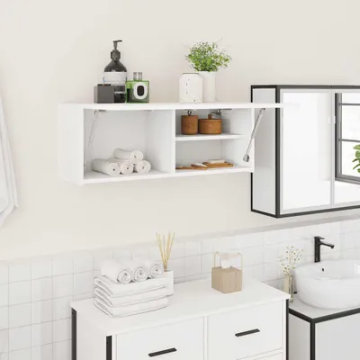 A white bathroom cabinet mounted on a white tiled wall, with various bathroom accessories on and around it.