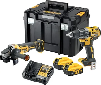 A set of DeWalt power tools including an angle grinder, a drill, batteries, a charger, and a storage case, arranged on a white background.