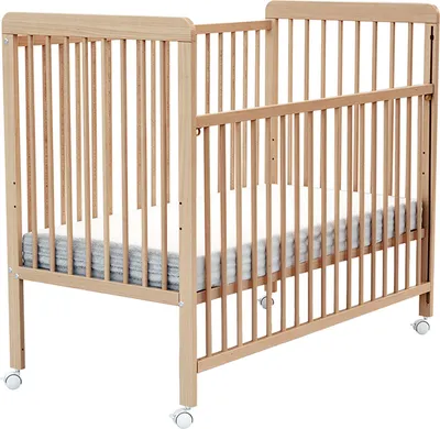A wooden baby crib with a mattress and bedding.
