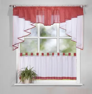 A window with curtains and a plant on the windowsill.
