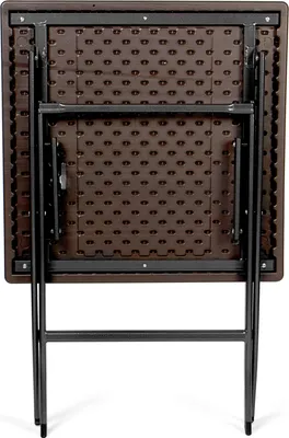 The back of a folded brown plastic table with black metal legs.