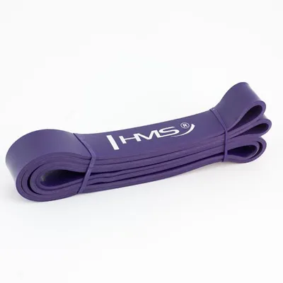 A purple exercise band is coiled and lying on a white background.