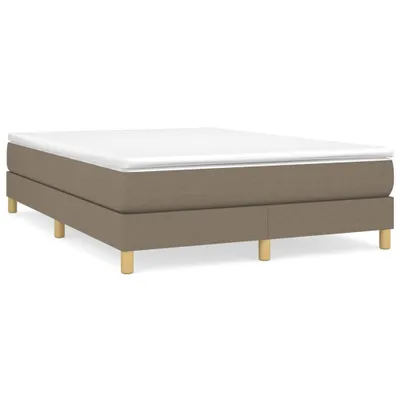 A taupe boxspring bed frame with a white mattress on top, shown from a side-angle.