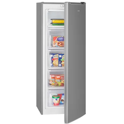 An open upright freezer filled with frozen food items.