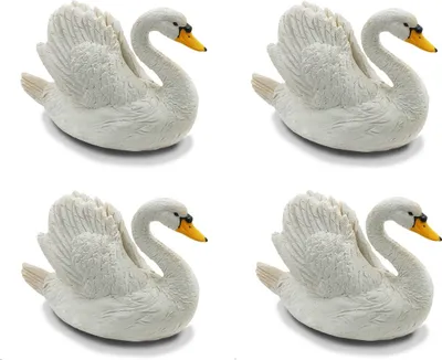 Four white decorative swan figurines are arranged in a grid on a white background.