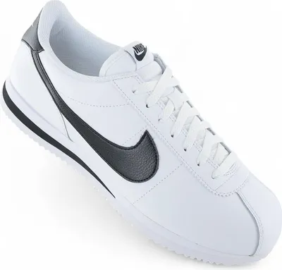 A white Nike Cortez sneaker with black accents is shown against a white background.
