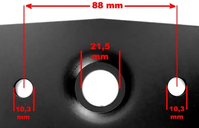 Close-up view of a black metal object with measurement annotations.