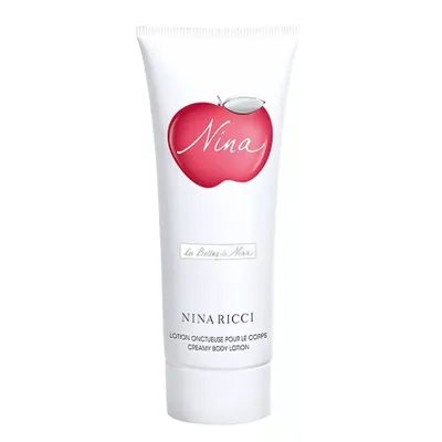 A white tube of Nina Ricci Nina Creamy Body Lotion with a red apple logo.