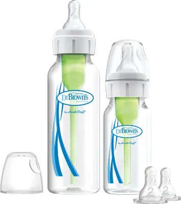 Two Dr. Brown's baby bottles of different sizes are shown against a white background. The larger bottle is on the left, and a smaller one is on the right. Accessories, including a cap and two nipples, are also visible.