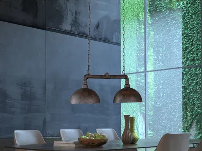 A dining room with a hanging industrial-style lamp over a table with chairs and decorative vases.