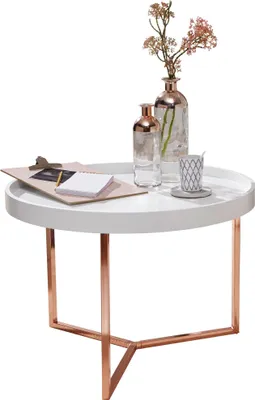 A white round coffee table with copper legs, decorated with two glass vases and a cup.