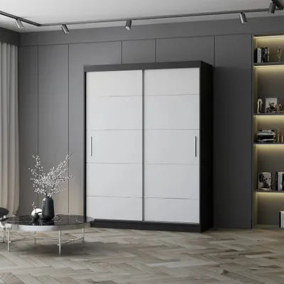 A modern bedroom or dressing room with a large sliding door wardrobe and a bookshelf.