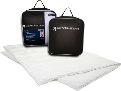 Two black storage bags with the Centa-Star logo and product information are placed behind two folded white duvets.