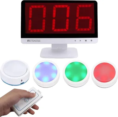 A wireless quiz buzzer system with a display screen and multiple buzzer units, shown with a hand holding a remote.