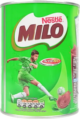 A can of Nestle Milo chocolate malt drink with a young boy playing soccer on the front.