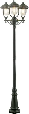 A black and green outdoor lamp post with three lights.