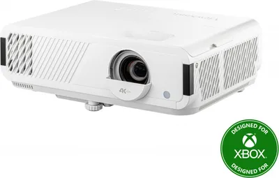 A white projector is shown from a diagonal angle against a white background. A green circular badge with the Xbox logo and text is in the bottom right corner.