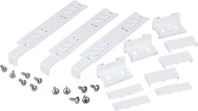 A collection of white plastic mounting brackets and silver screws are laid out on a white background.