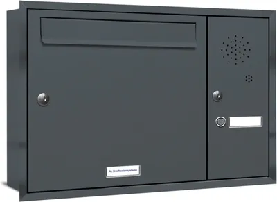 A dark gray mailbox with a mail slot, a door with a lock, a speaker grille, a button, and a nameplate.
