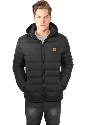 A man wearing a black hooded puffer jacket.