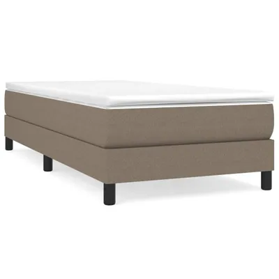 A taupe box spring bed frame with a white mattress topper and black legs, shown against a white background.