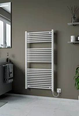 A white electric towel warmer is mounted on a gray wall in a bathroom. The floor is tiled with white marble.