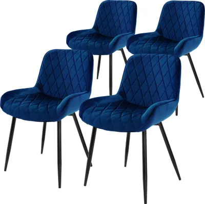 Four blue velvet dining chairs with black metal legs, arranged diagonally.