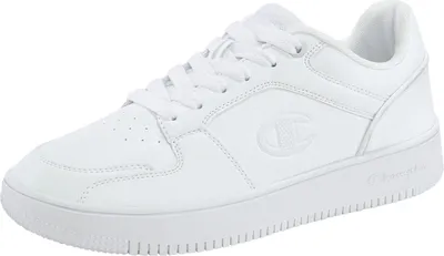 A white Champion Rebound 2.0 Low sneaker is shown from a side angle against a white background.
