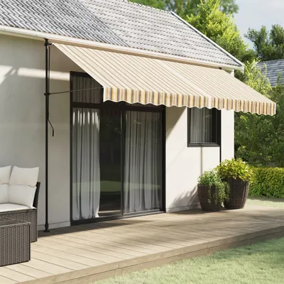 Awnings extended over a sliding glass door on a house, with a deck and outdoor furniture.
