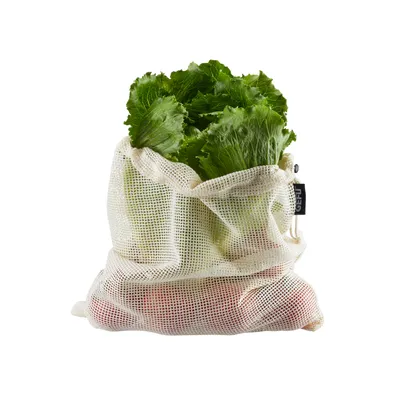 A reusable mesh bag filled with fresh produce, including lettuce and tomatoes.