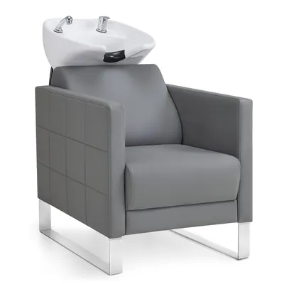 A salon shampoo chair with a ceramic basin and chrome faucets, presented against a white background.
