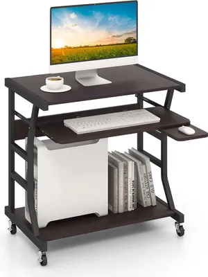 A computer desk with a monitor, keyboard, computer tower, and books.
