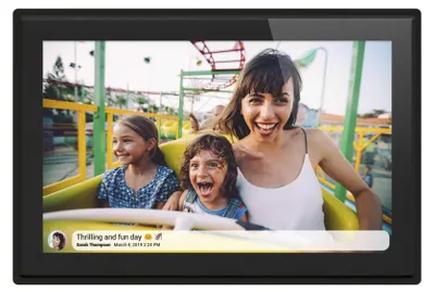 A digital photo frame displaying a family on a roller coaster ride.
