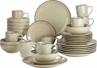 A collection of beige ceramic dishes and mugs are arranged on a white background.