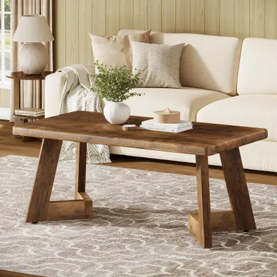 A living room scene with a couch, coffee table, and lamp.
