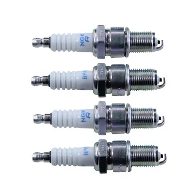 Four spark plugs are arranged vertically against a white background.