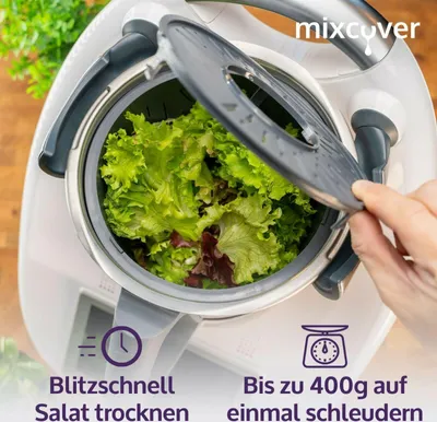 A kitchen appliance with lettuce inside, being operated by a hand.