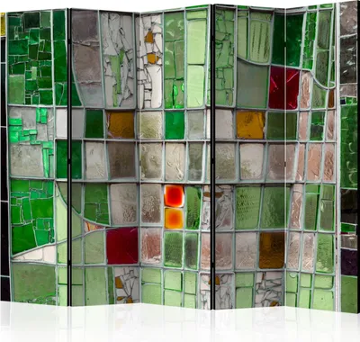 A room divider made of stained glass panels in various shades of green, red, and yellow.