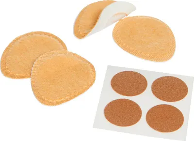 A collection of orange-colored corn/callus plasters on a white background.